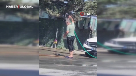 Sultangazi'de sıcaktan bunaldı: Hortumla önce kendini sonra aracını yıkadı
